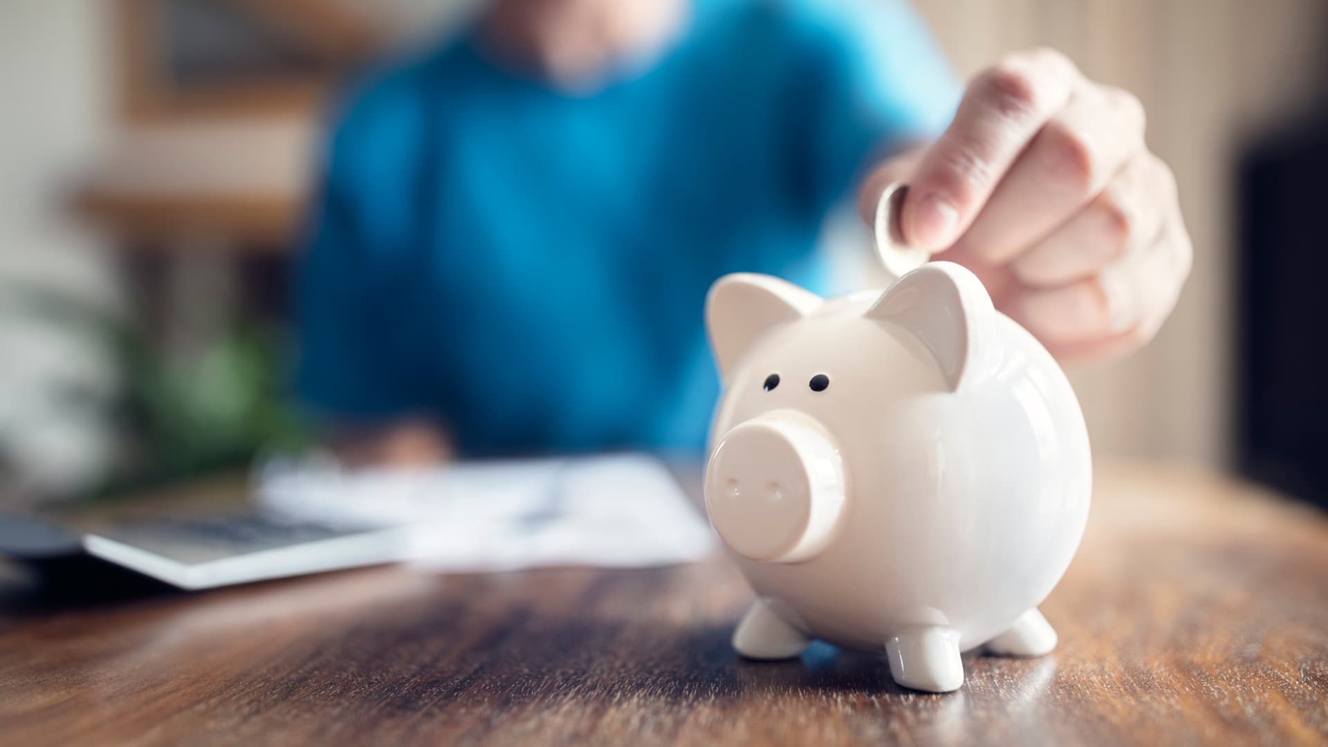 Person saving money in a piggy bank